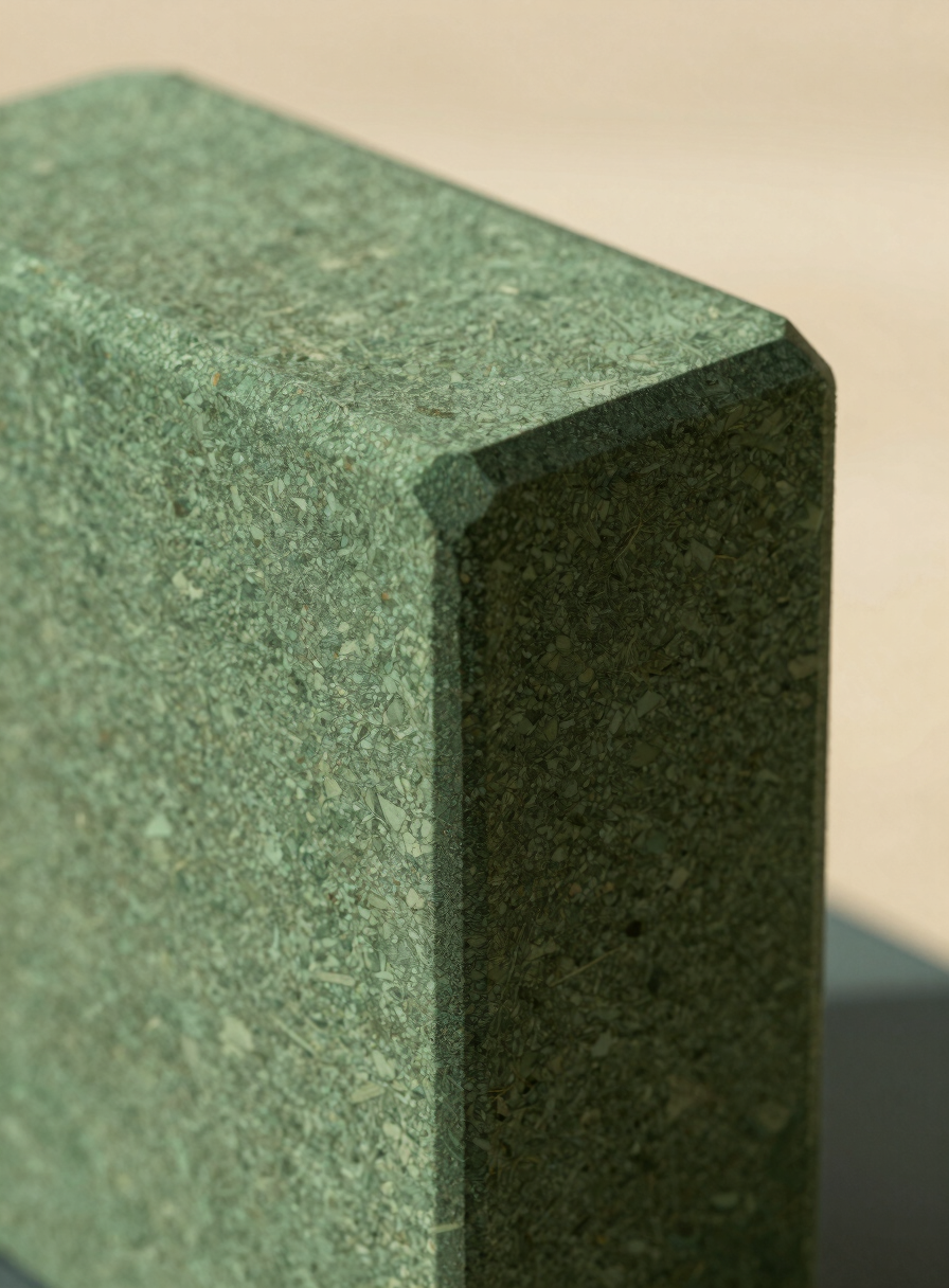 Close-up of a premium yoga block, showing the fine texture of high-density cork, clean beveled edge, warm daylight, elegant shadow, 35mm